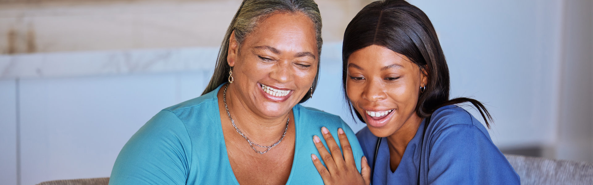 nurse and elderly woman smiling