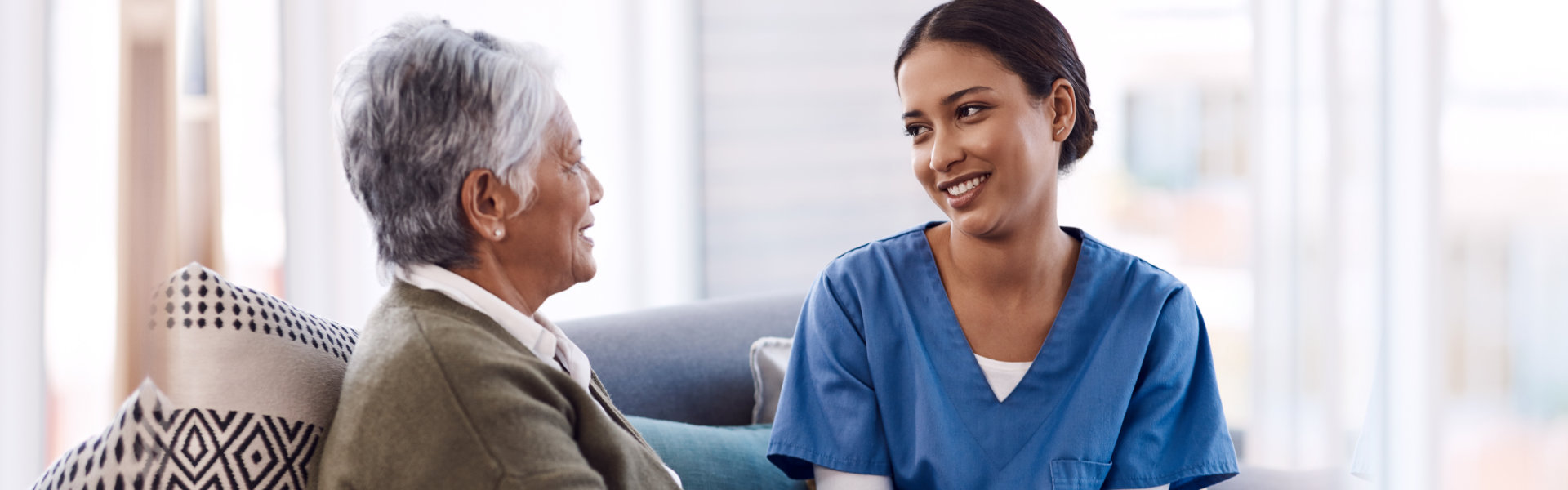 nurse comforting elderly woman