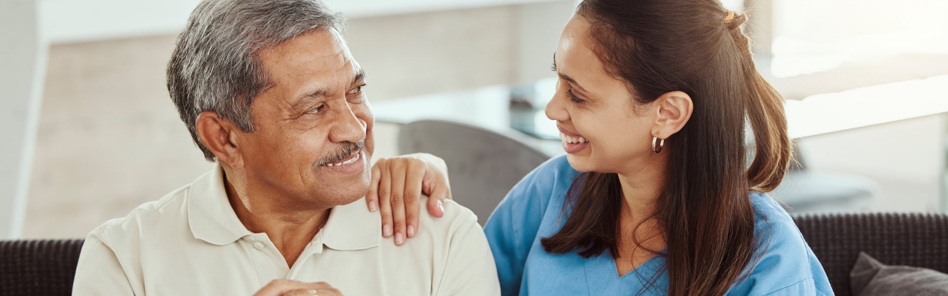 nurse with elderly man looking at each other