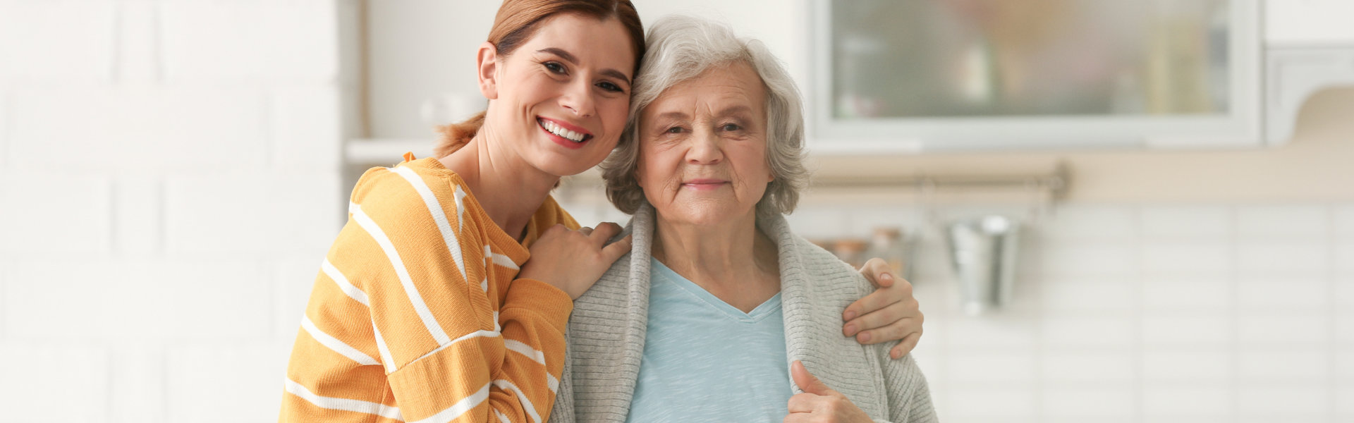 woman hugging elderly woman